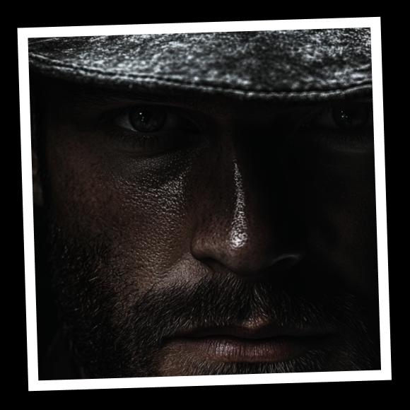 A gaze of a confident man in a hat