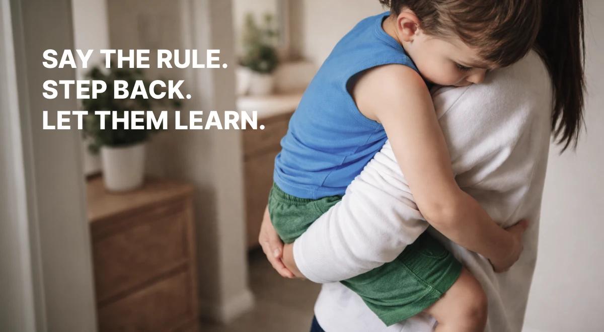 Mother hugging an upset child in a blue shirt indoors near a wooden dresser and potted plant, capturing a fafo vs gentle parenting comforting moment