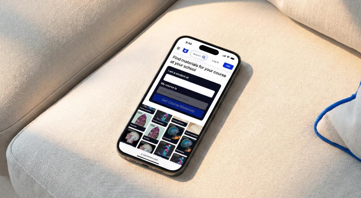 Smartphone lying on a beige fabric sofa displaying the Course Hero app interface for finding course study materials, with a blue rope visible in the background