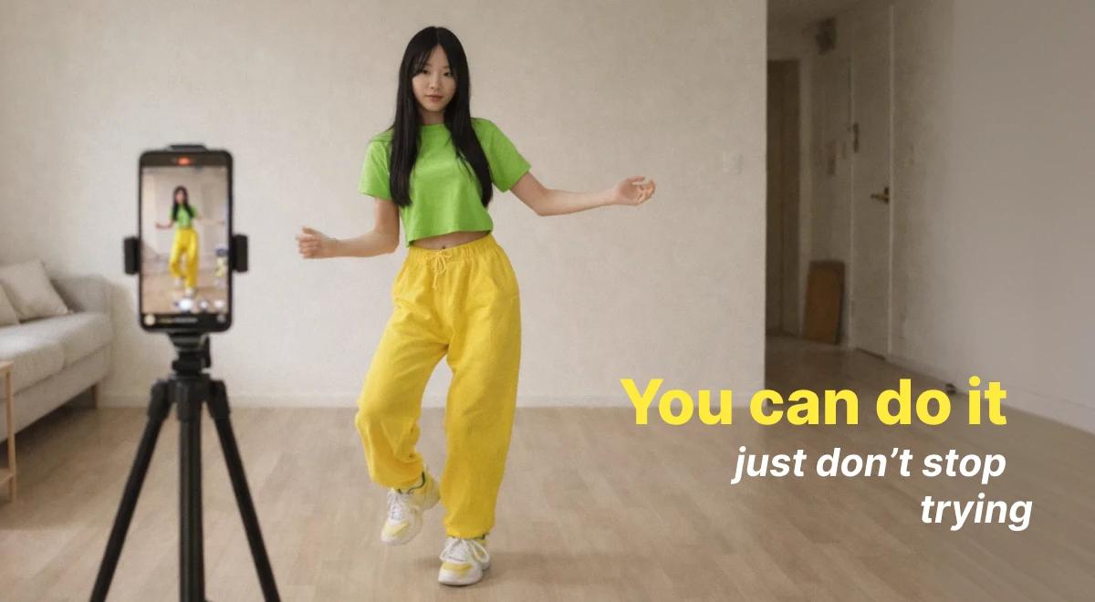 Young woman in a green top and yellow pants dancing in front of a smartphone on a tripod, creating viral social media video content indoors