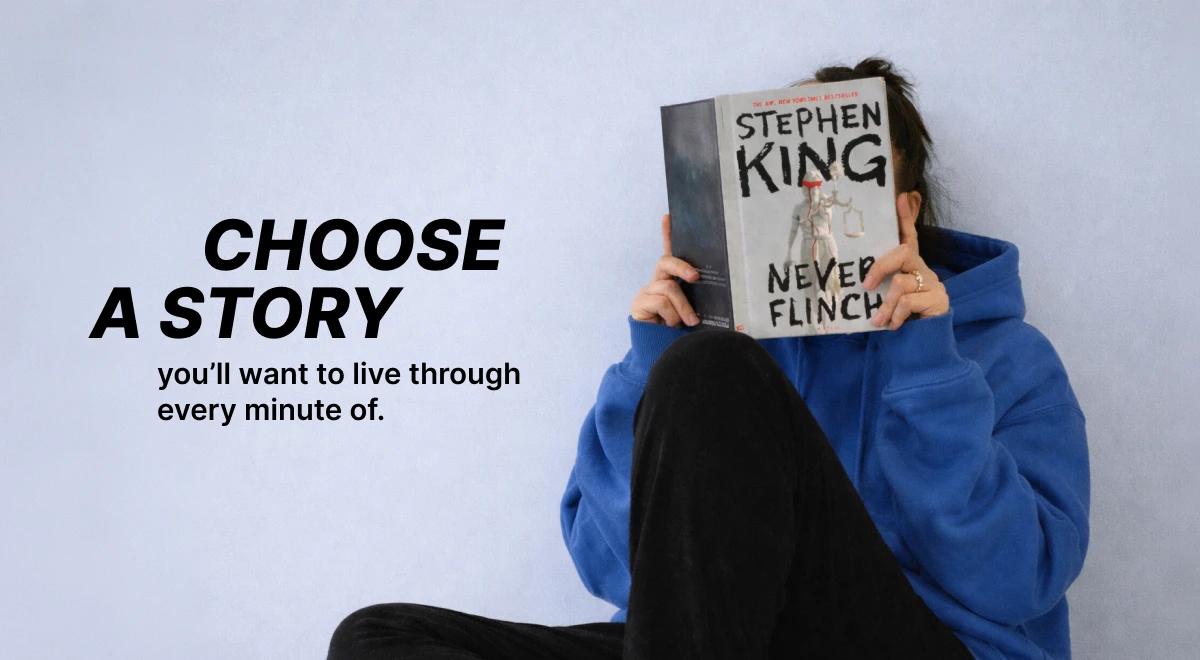Woman in a blue hoodie holding a Stephen King Never Flinch book over her face against a light blue background, promoting listening to thriller audiobooks