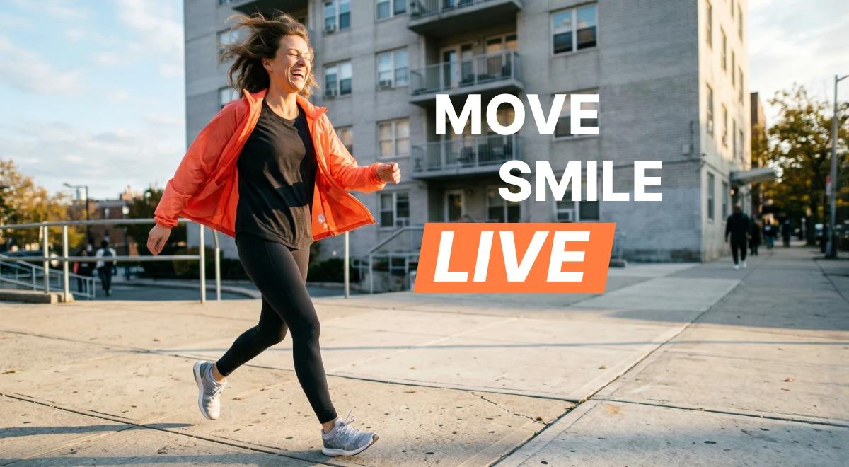 Smiling woman in a red jacket jogging outdoors past urban buildings on a sunny day, embracing an active morning routine for ultimate productivity