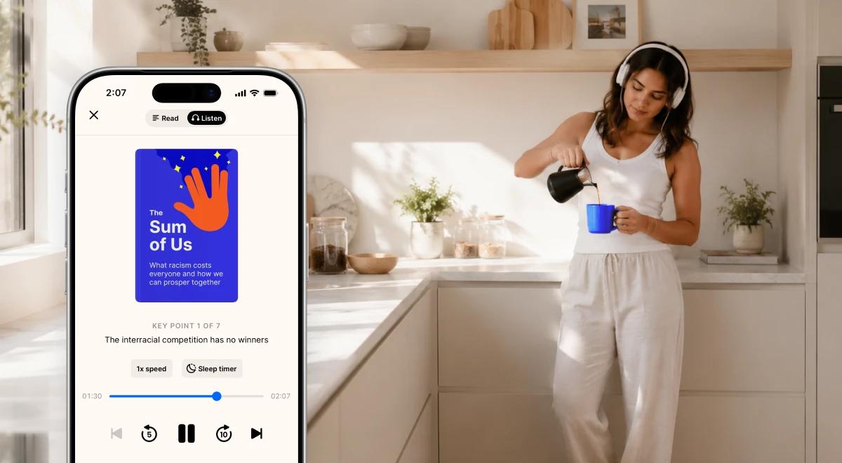 Woman in white outfit wearing headphones pouring coffee in a sunny kitchen, with an iPhone showing The Sum of Us audiobook playing in the Librofm or similar audio app