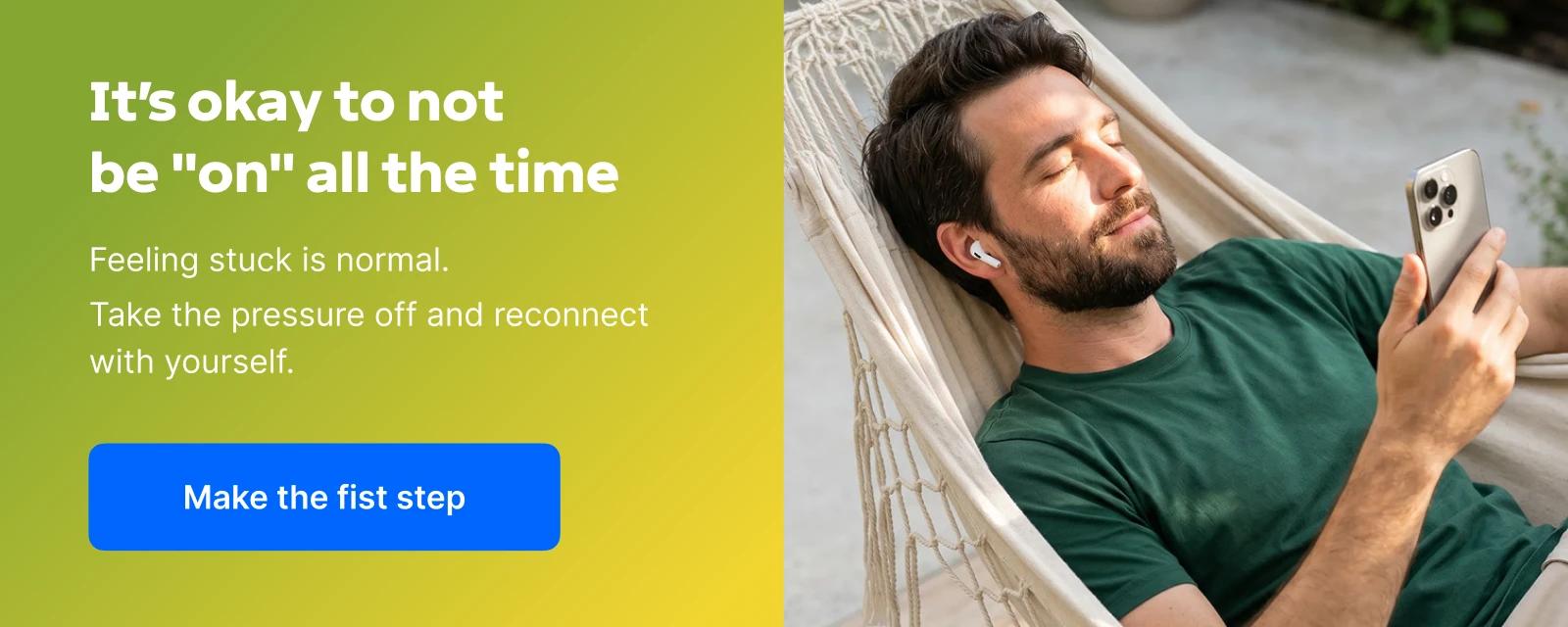 Calm bearded man in a green t-shirt resting in a white hammock, wearing wireless earbuds and holding a smartphone while enjoying the Headway microlearning app, with a relaxing outdoor setting behind h