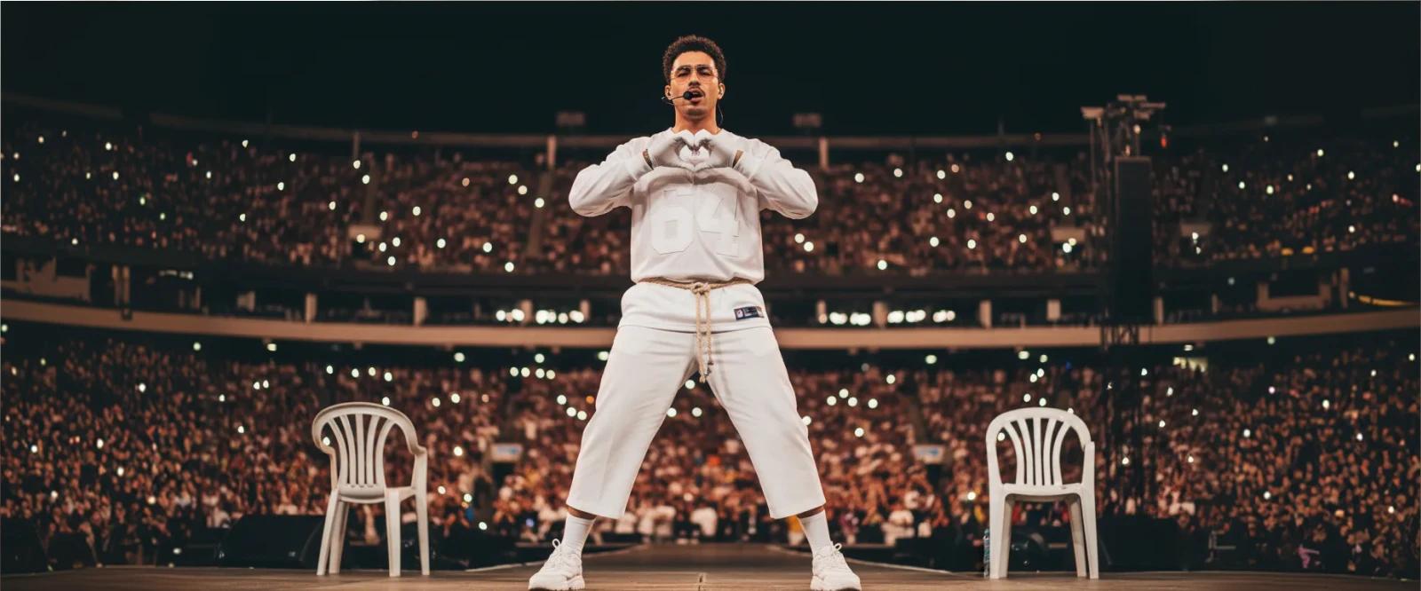 Bad Bunny performing on stage in white outfit making heart gesture to crowd at packed stadium during Super Bowl halftime show
