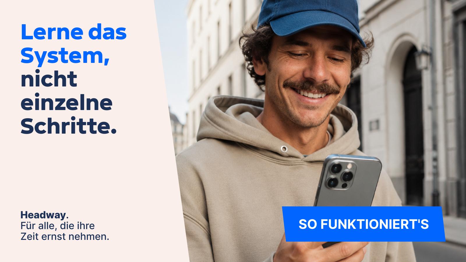 Lächelnder Mann mit Cap und beigem Hoodie nutzt sein Smartphone auf einer Straße, mit Werbetext zur Headway App über das Lernen von Systemen statt einzelner Schritte