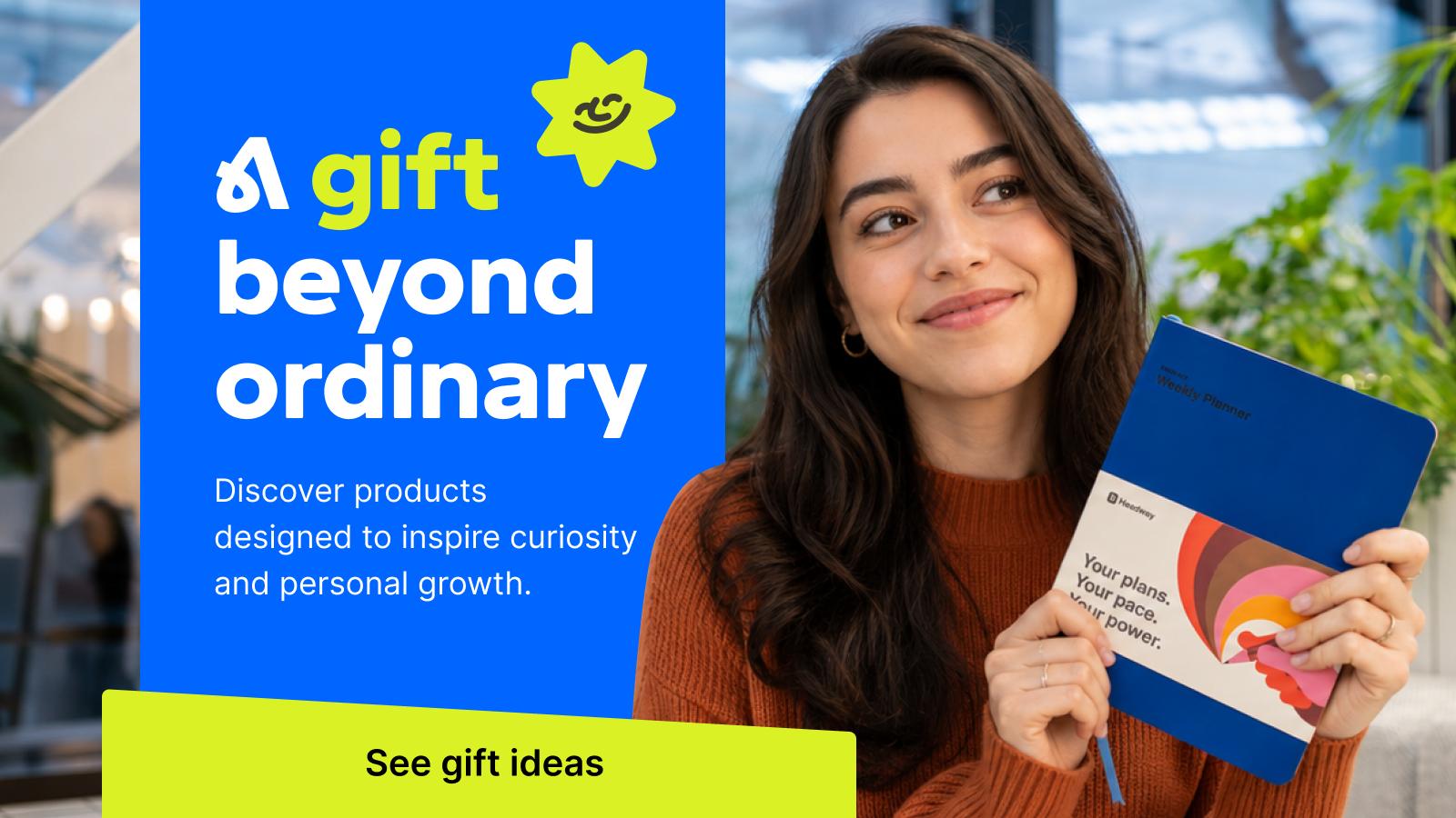 Smiling woman with long brown hair holding a blue Headway journal weekly planner beside a gift beyond ordinary promo banner inspiring curiosity and personal growth