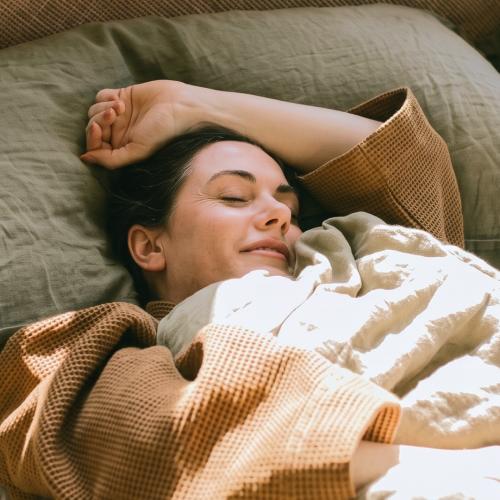 A woman cozily sleeps dealing with overthinking