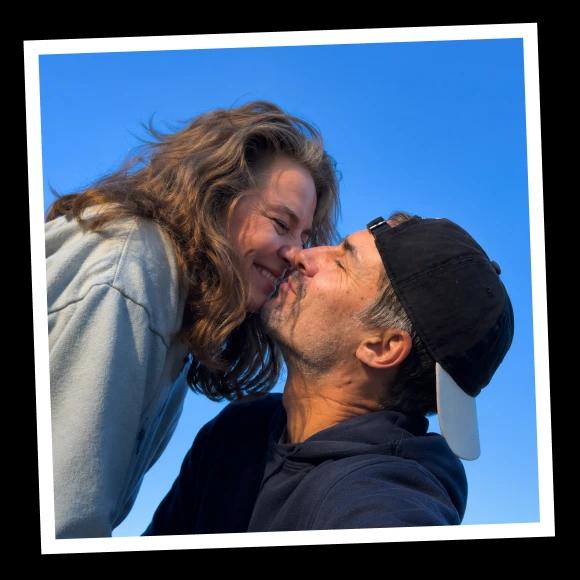 A happy couple in their 40s kissing